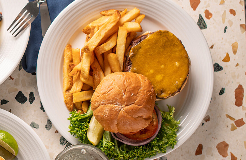 100% Oregon grass-fed ad finished beef from High Desert Grass Fed Natural Beef. A half-pound burger char-grilled to your specifications with Tillamook Cheddar, Swiss, Pepper Jack, or Jack cheese. Served with lettuce, tomato, and onion on a grilled pub bun.